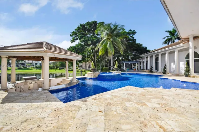 a living room with fireplace furniture and a large mirror