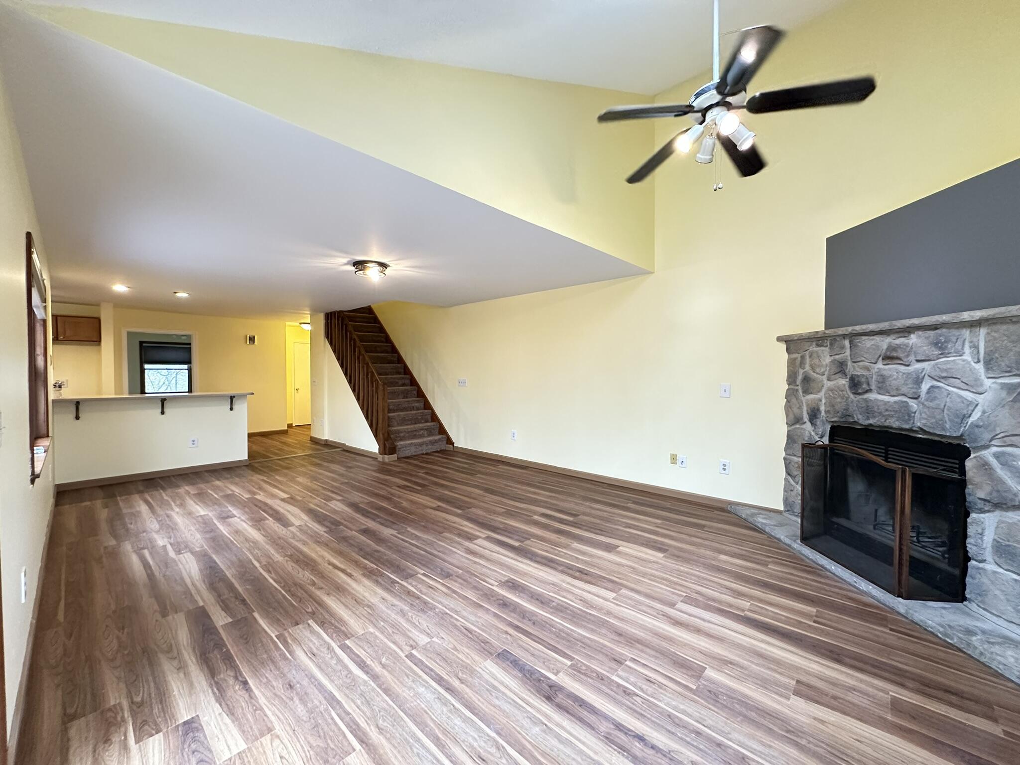 227 Image Drive Scotrun, PA 18355 - Photo 17 of 37 a view of a livingroom with a fireplace a ceiling fan and wooden floor