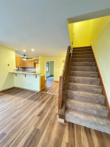 a view of a kitchen with wooden floor and a sink