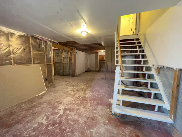 a view of a room with stairs and wooden floor