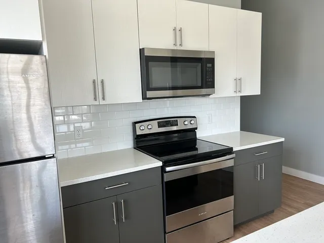 a kitchen with a stove and a microwave