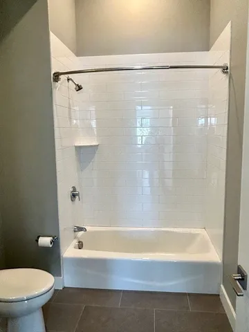 a bathroom with a shower and a toilet