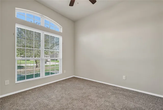 an empty room with a empty space and windows