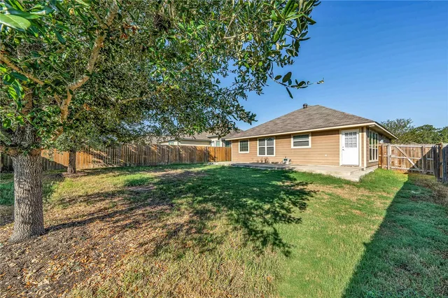 a front view of a house with yard and green space