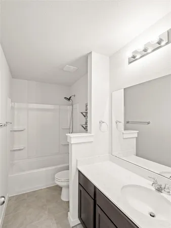 an empty room with closet and a ceiling fan