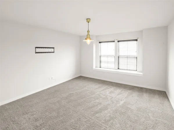 a view of a bedroom with wooden floor