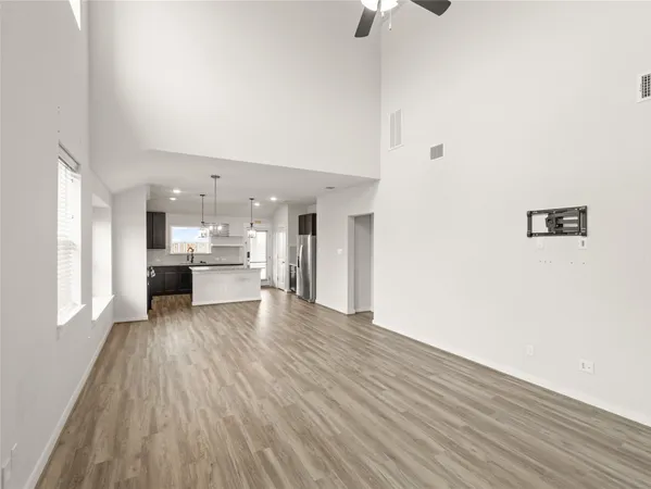 a kitchen with stainless steel appliances granite countertop a sink a counter space cabinets and wooden floor