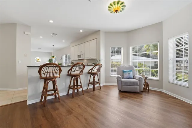 a livingroom with furniture stove and wooden floor