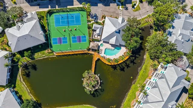 an aerial view of a house with a yard and swimming pool