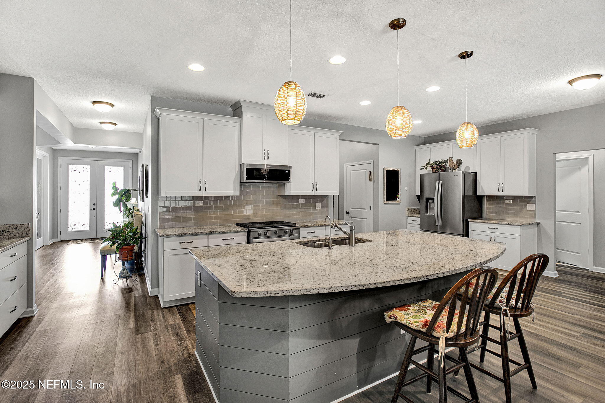 424 Willow Lake Drive St. Augustine, FL 32092 - Photo 12 of 52 a kitchen with stainless steel appliances kitchen island granite countertop a kitchen island a stove a table and chairs in it