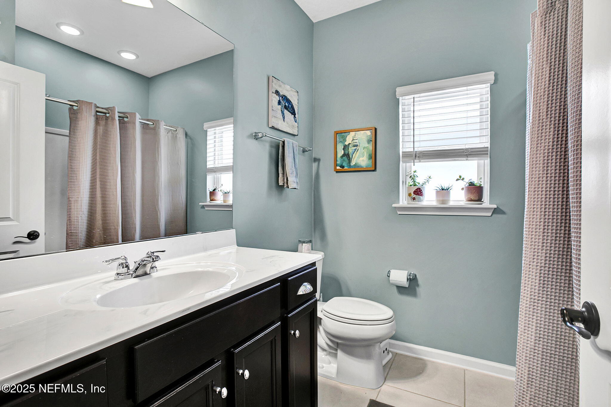 424 Willow Lake Drive St. Augustine, FL 32092 - Photo 26 of 52 a bathroom with a sink a toilet a mirror and a window