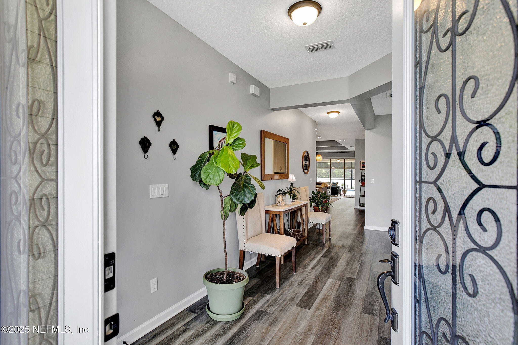424 Willow Lake Drive St. Augustine, FL 32092 - Photo 7 of 52 a dining room with furniture a potted plant and wooden floor