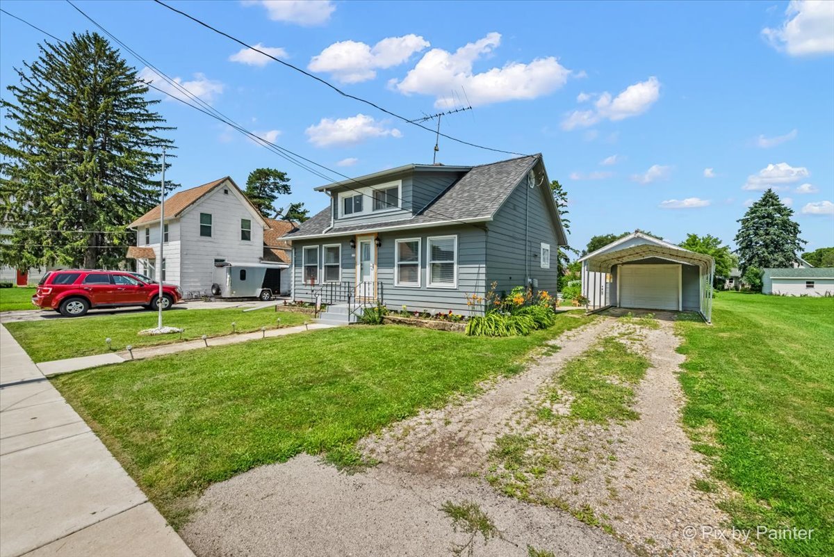 335 Ogden Street Capron, IL 61012 - Photo 3 of 18 a front view of a house with a yard and garage