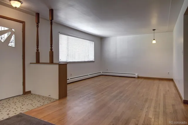 wooden floor in an empty room with a window
