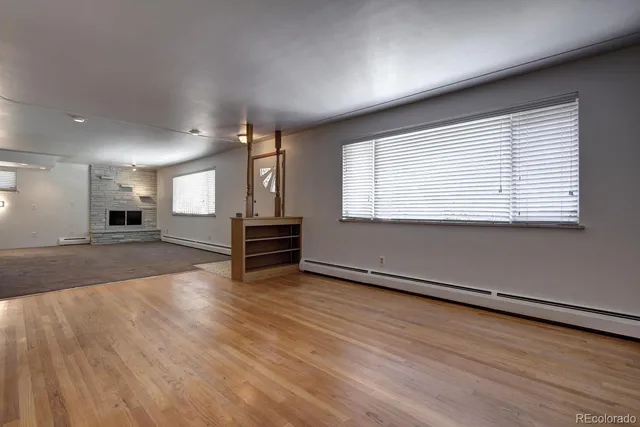 an empty room with wooden floor and a window