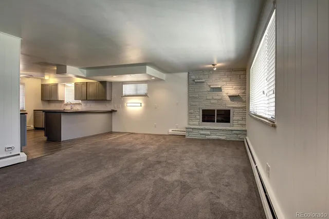 a kitchen with granite countertop cabinets stainless steel appliances a sink and a window