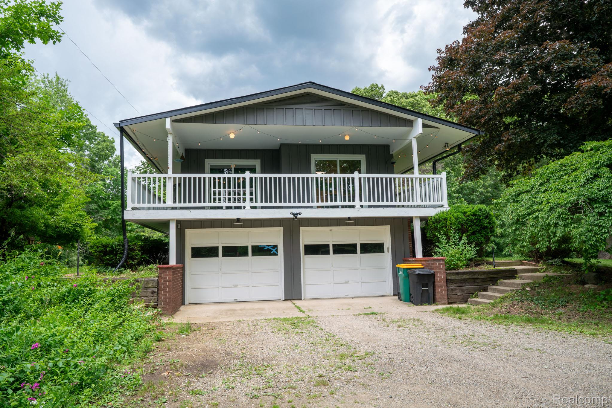 7333 Toma Road Dexter, MI 48130 - Photo 4 of 45 Contemporary multi-level residence featuring gray siding and a black roof