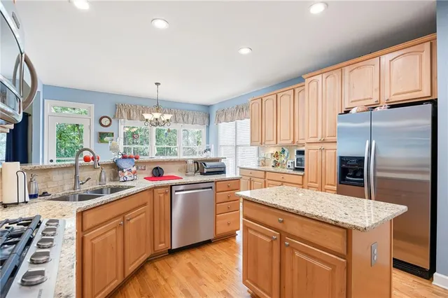 a kitchen with a sink stove and refrigerator