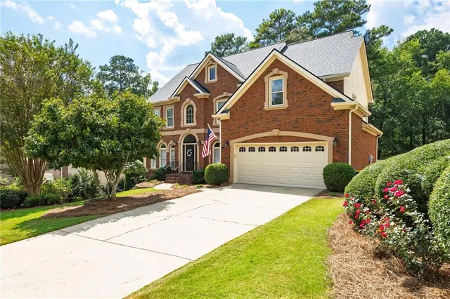 a front view of a house with a yard and garage