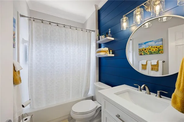 a bathroom with a sink toilet and mirror