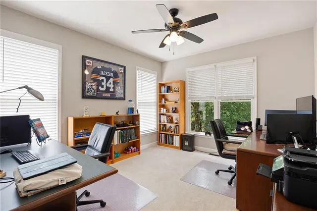 a view of a workspace with furniture and a window
