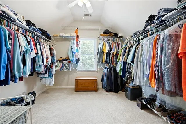 a bed room with a bed and a book shelf