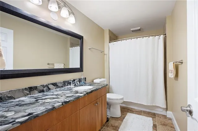 a kitchen with stainless steel appliances granite countertop a sink and stove