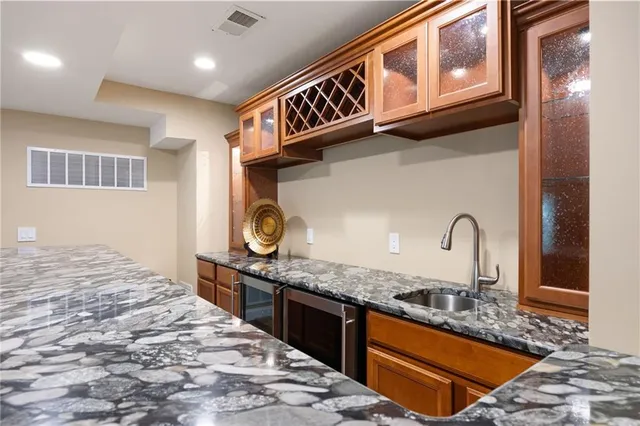 a view of an empty room with furniture and a window