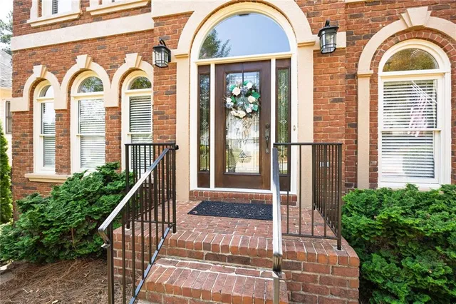 a view of a brick house with a large windows