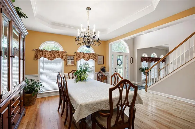 a view of a dining room with furniture chandelier and wooden floor