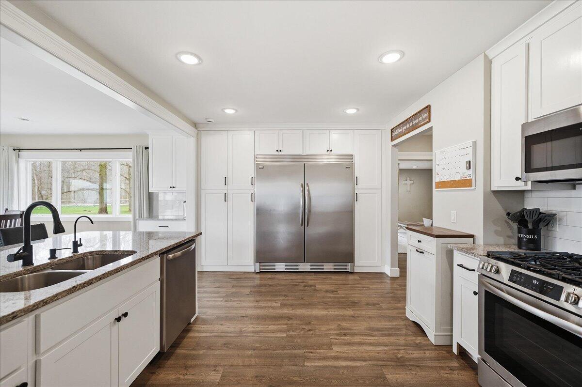 6411 East 129th Avenue Crown Point, IN 46307 - Photo 13 of 79 a kitchen with stainless steel appliances granite countertop a sink a stove and a refrigerator