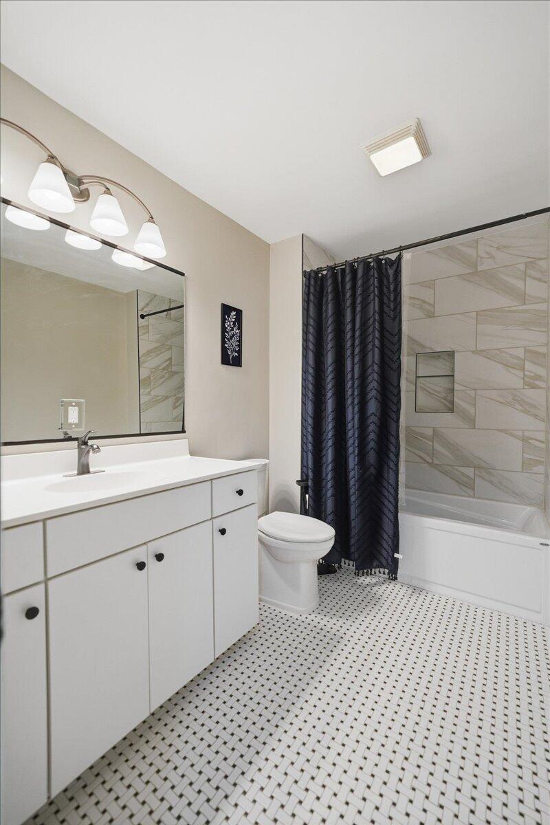 6411 East 129th Avenue Crown Point, IN 46307 - Photo 22 of 79 a bathroom with a double vanity sink toilet and shower