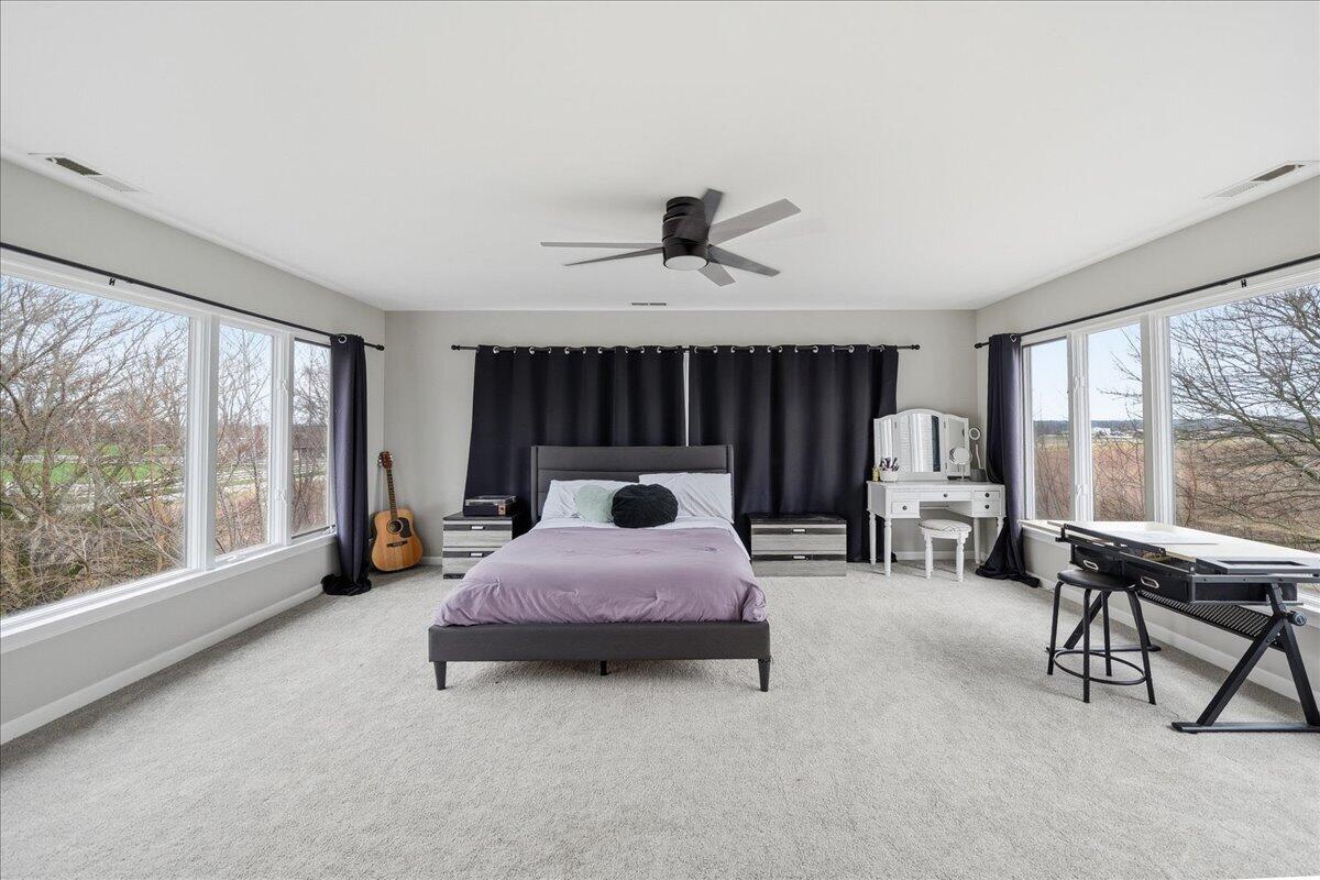 6411 East 129th Avenue Crown Point, IN 46307 - Photo 23 of 79 a bed room with a bed and a large window