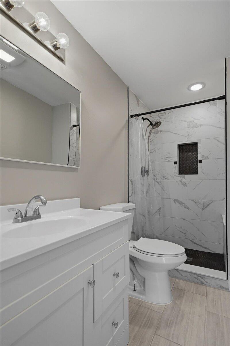 6411 East 129th Avenue Crown Point, IN 46307 - Photo 25 of 79 a bathroom with a sink a toilet and shower