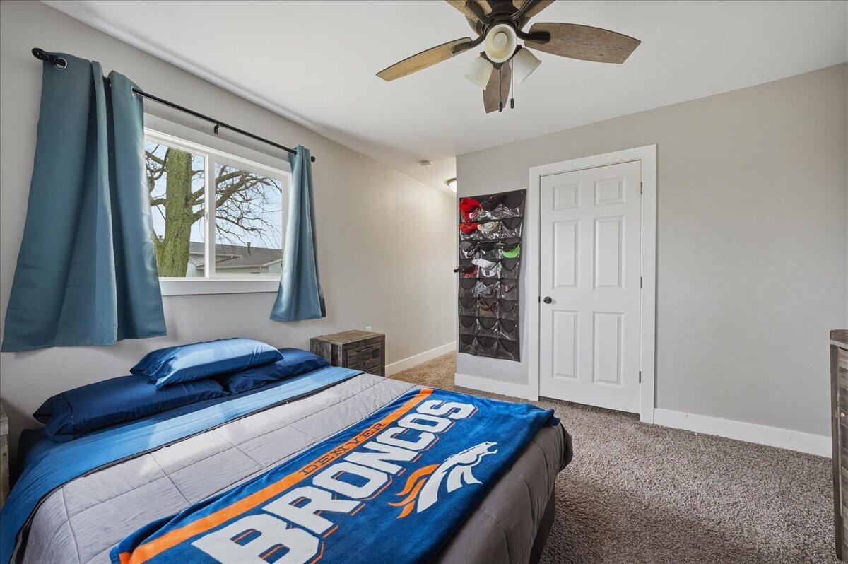 6411 East 129th Avenue Crown Point, IN 46307 - Photo 26 of 79 a bedroom with a bed and a chandelier