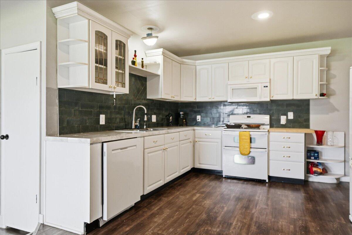 6411 East 129th Avenue Crown Point, IN 46307 - Photo 34 of 79 a kitchen with white cabinets and white appliances