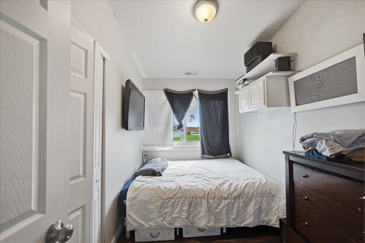 6411 East 129th Avenue Crown Point, IN 46307 - Photo 36 of 79 a bedroom with a bed and cabinets
