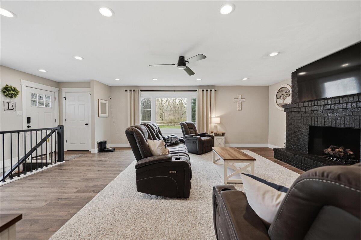 6411 East 129th Avenue Crown Point, IN 46307 - Photo 38 of 79 a living room with furniture a fireplace and a flat screen tv