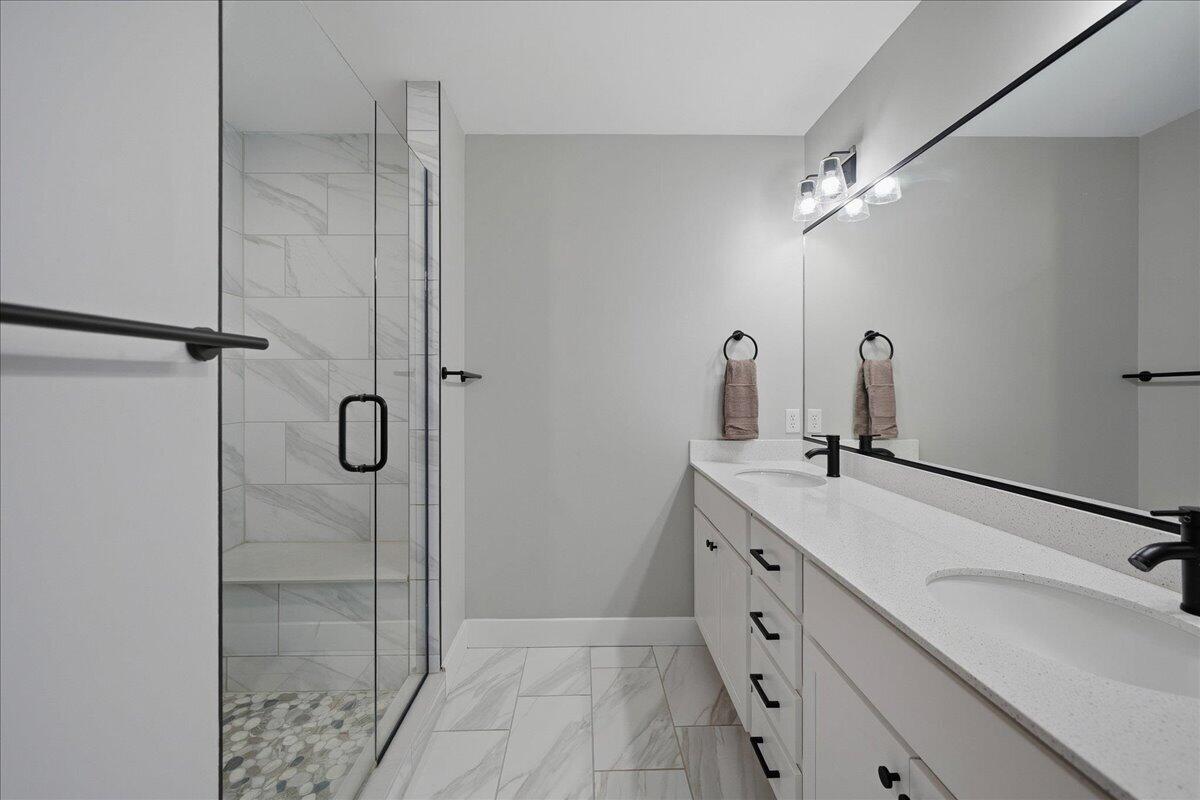 6411 East 129th Avenue Crown Point, IN 46307 - Photo 42 of 79 a bathroom with a double vanity sink mirror and shower
