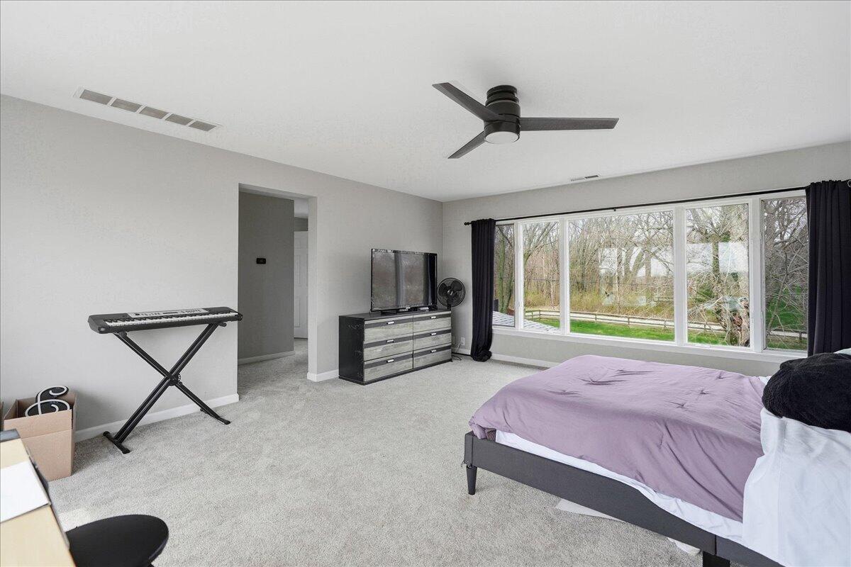 6411 East 129th Avenue Crown Point, IN 46307 - Photo 48 of 79 a bed room with a bed and a large window