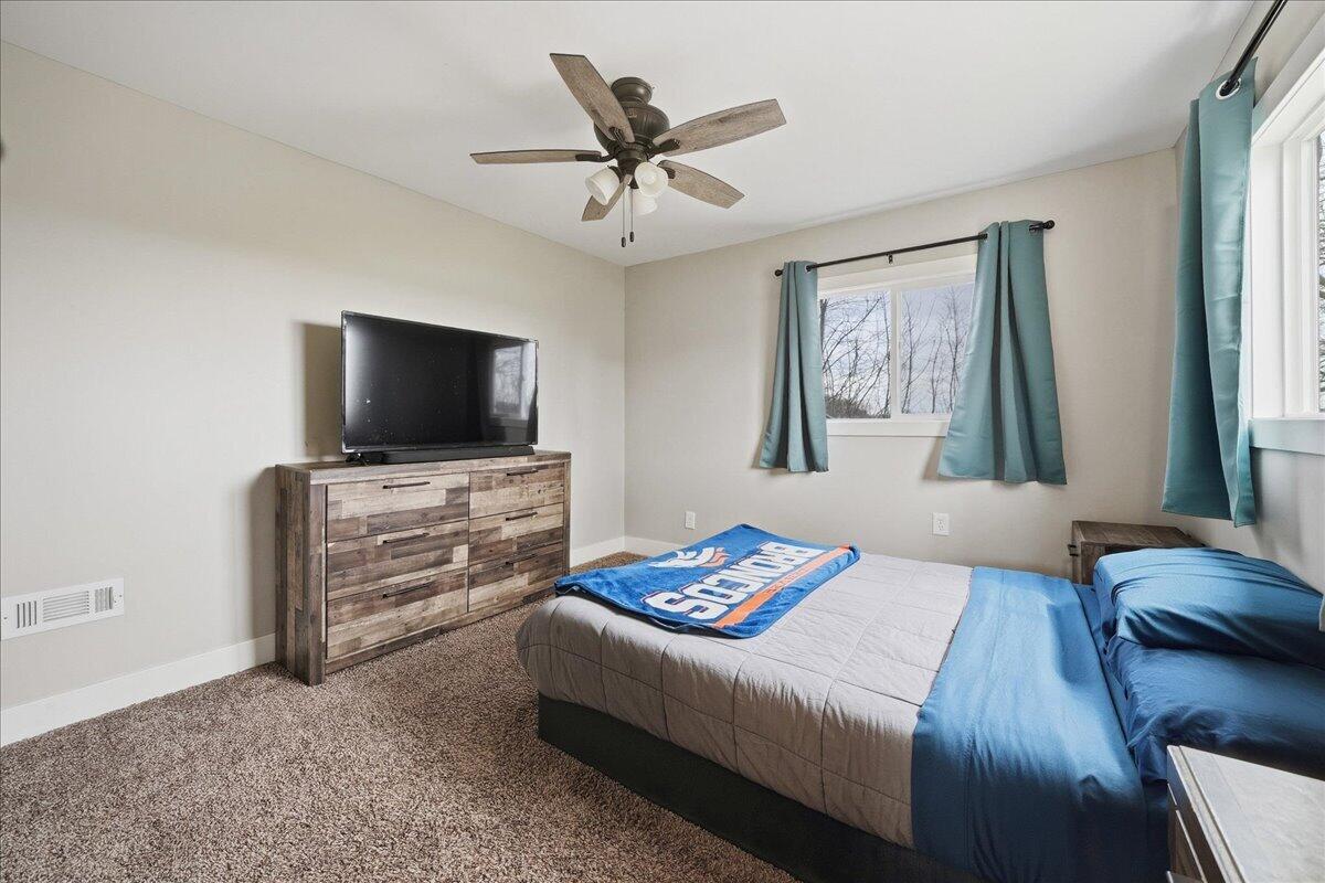 6411 East 129th Avenue Crown Point, IN 46307 - Photo 49 of 79 a bedroom with a bed and a flat screen tv