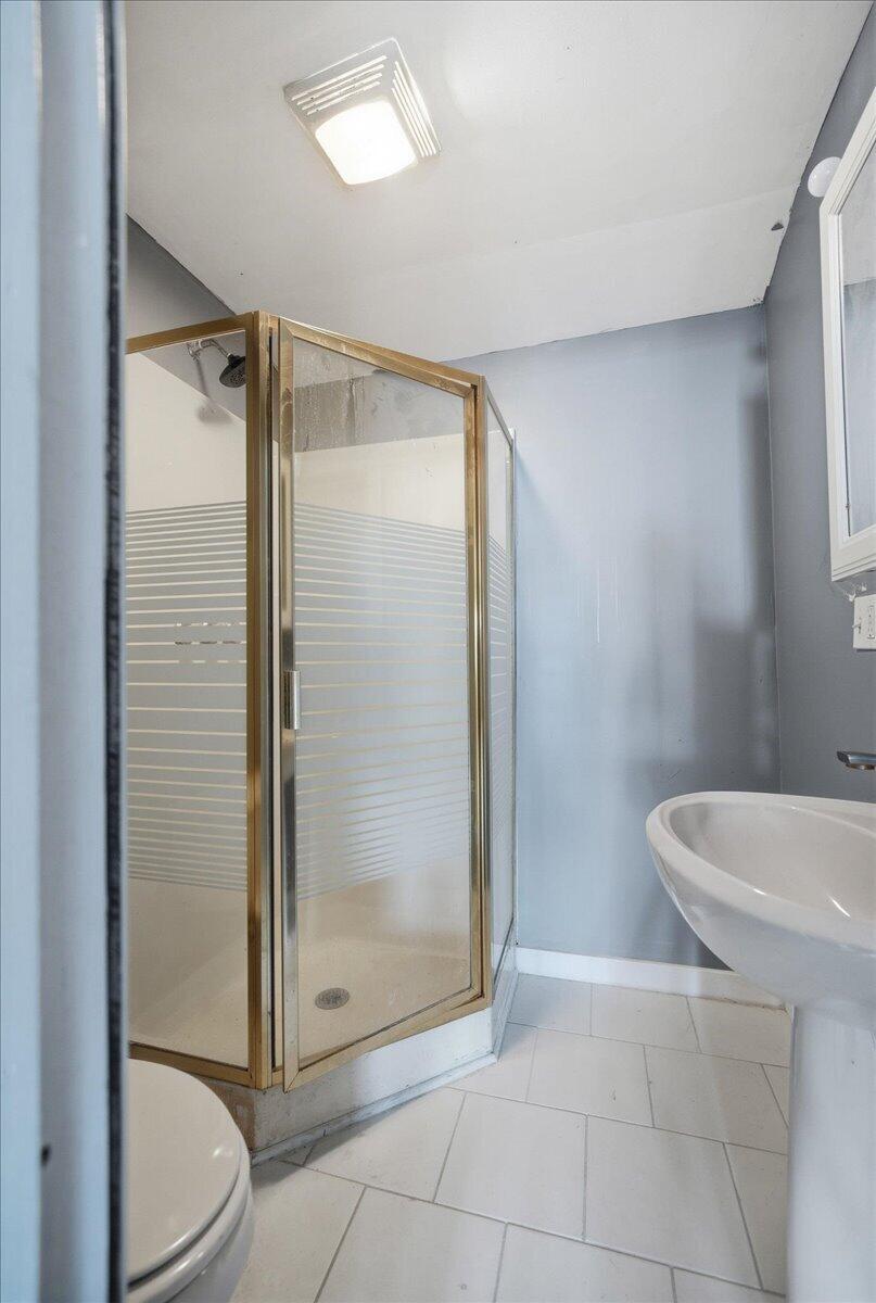 6411 East 129th Avenue Crown Point, IN 46307 - Photo 52 of 79 a bathroom with a shower a toilet and a sink