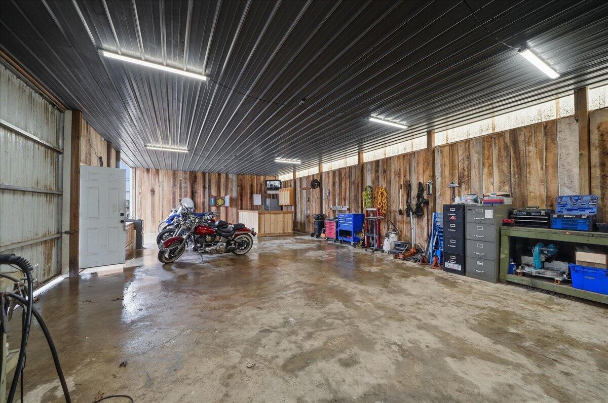 6411 East 129th Avenue Crown Point, IN 46307 - Photo 59 of 79 a view of a garage with a bike and white walls