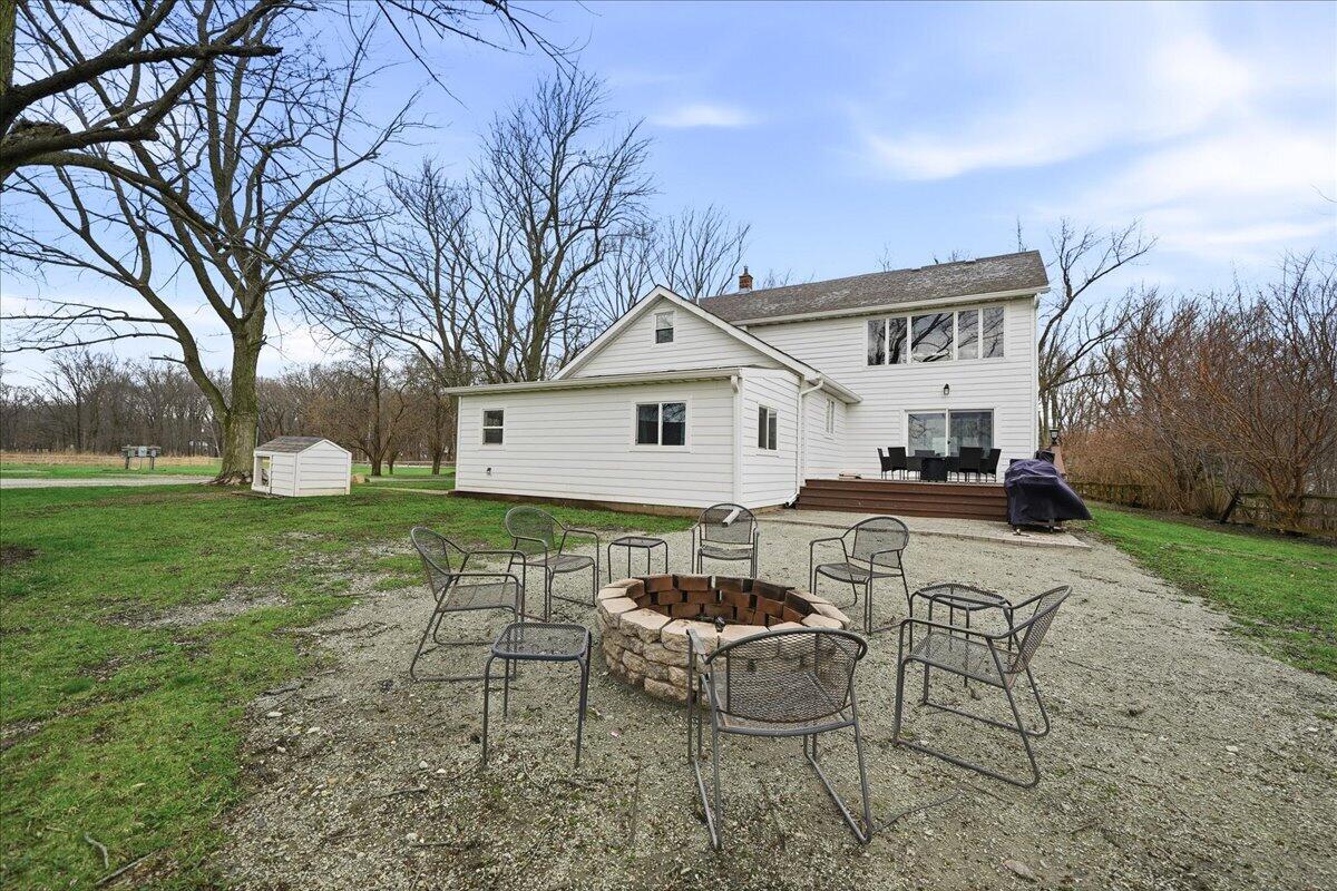6411 East 129th Avenue Crown Point, IN 46307 - Photo 65 of 79 a view of a white house with a yard and sitting area