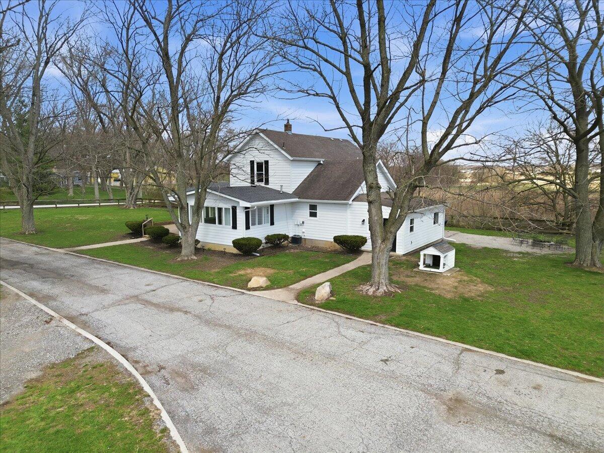 6411 East 129th Avenue Crown Point, IN 46307 - Photo 72 of 79 a view of a house with a big yard and large trees