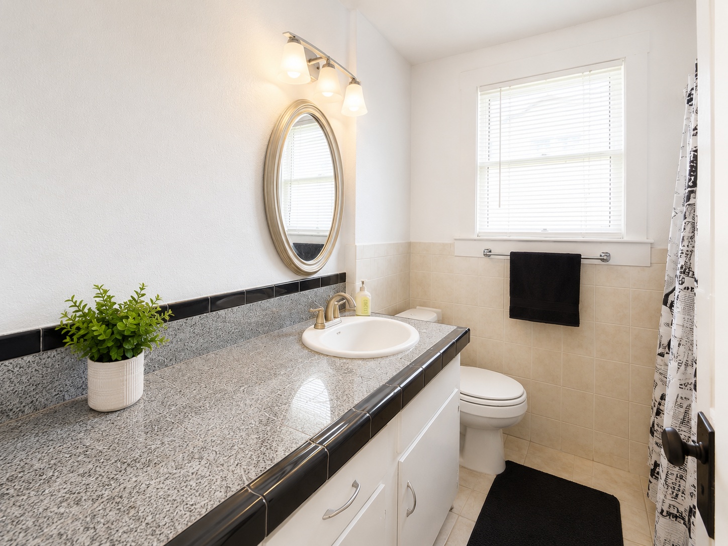 404 West 43rd Street, Unit A Austin, TX 78751 - Photo 8 of 10 a bathroom with a granite countertop sink a toilet and a mirror