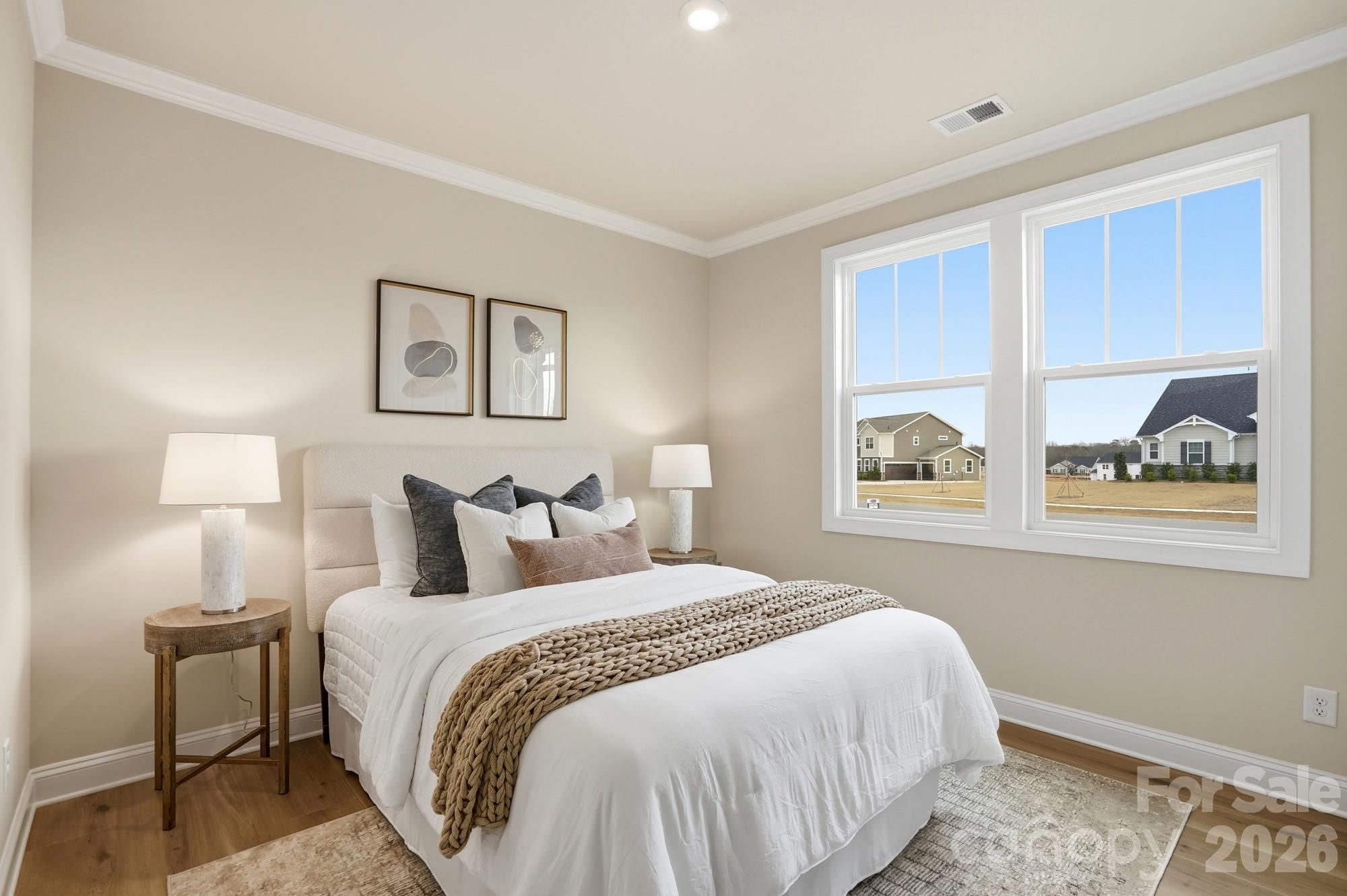 2549 Mabel Lane Monroe, NC 28110 - Photo 19 of 28 a bedroom with bed and wall painting with wooden floor