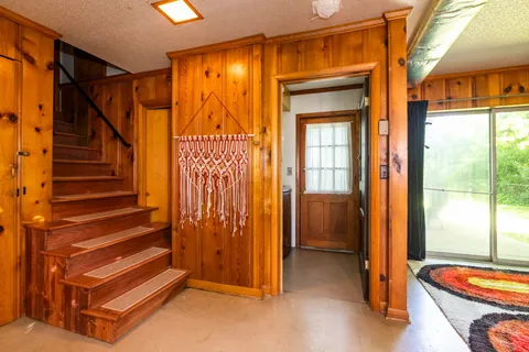 a living room with lots of furniture and a large window