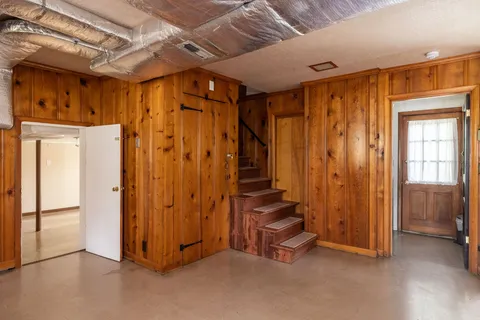 a view of hallway with furniture and a large window