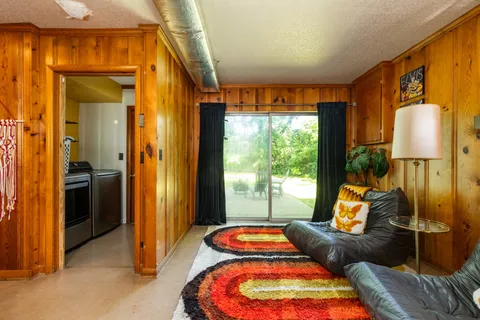 a bedroom with furniture and large windows